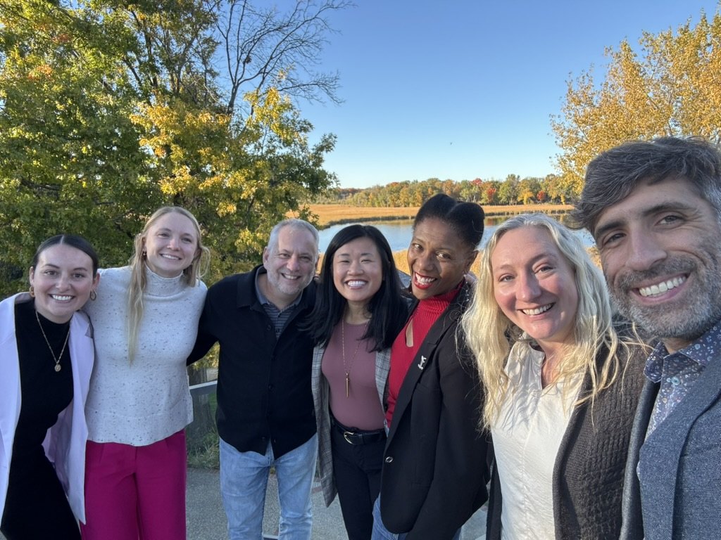 Daniel with an EOS client leadership team outdoors on a fall session day